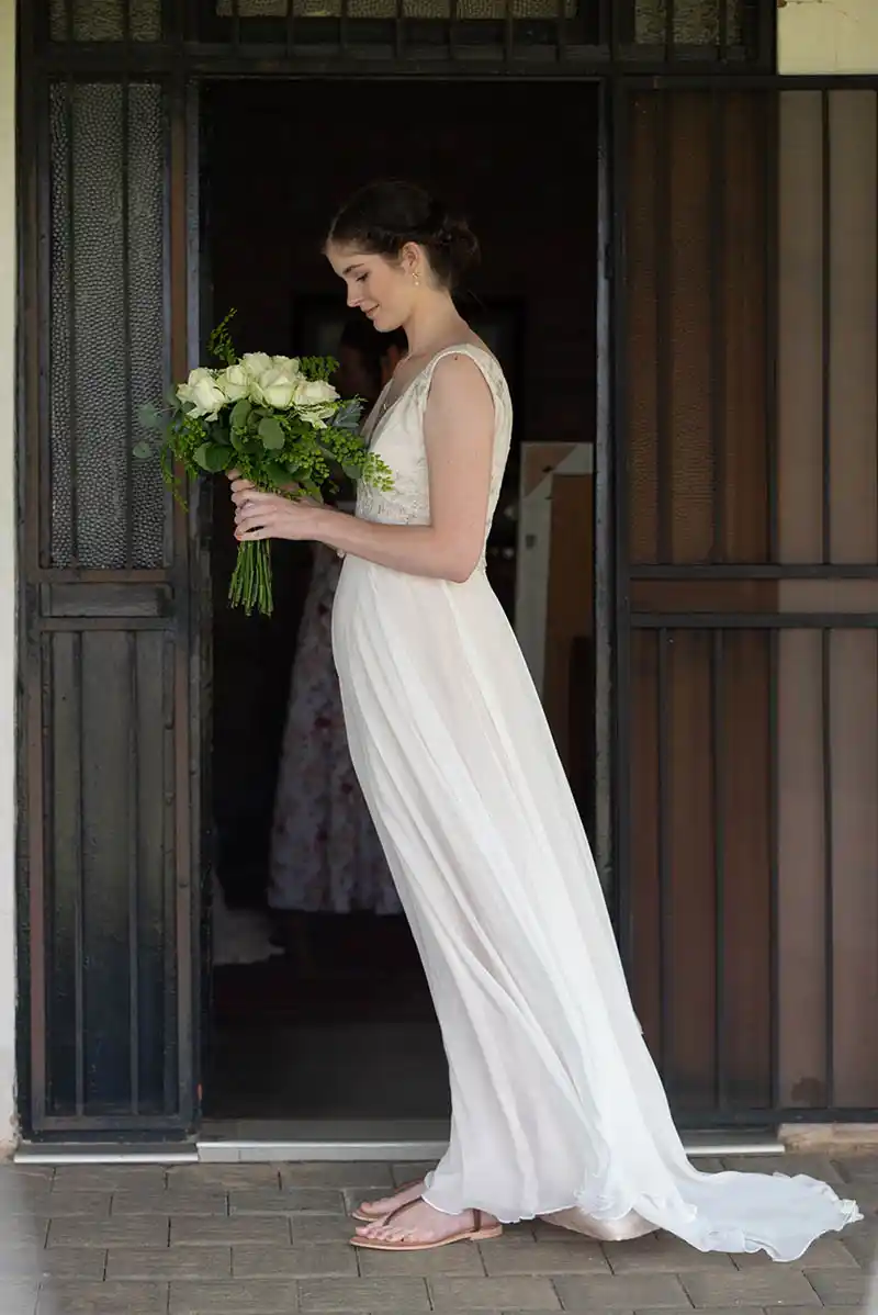 Bride looking at flowers bloemfontein wedding