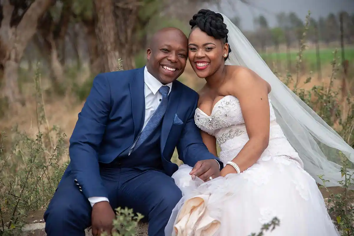happy wedding couple blue suite bride bloemfontein sandstone sleeper estate wedding photographer